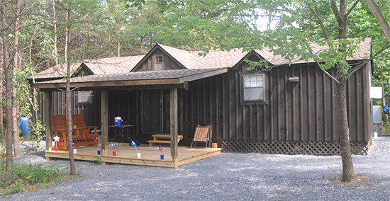 Custom Board 'N' Batten Peak Cabin with roof dormers built by Pine Creek Structures
